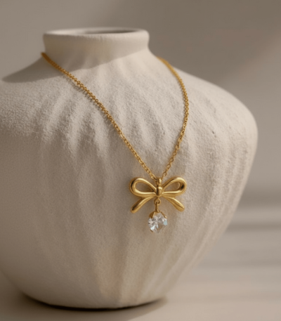 Gold Bow Necklace With Heart Shaped Diamond Pendant