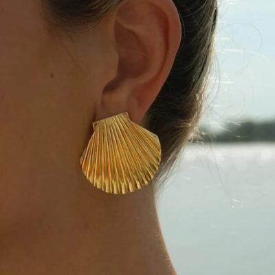 18k gold-plated seashell stud earring worn close-up on ear