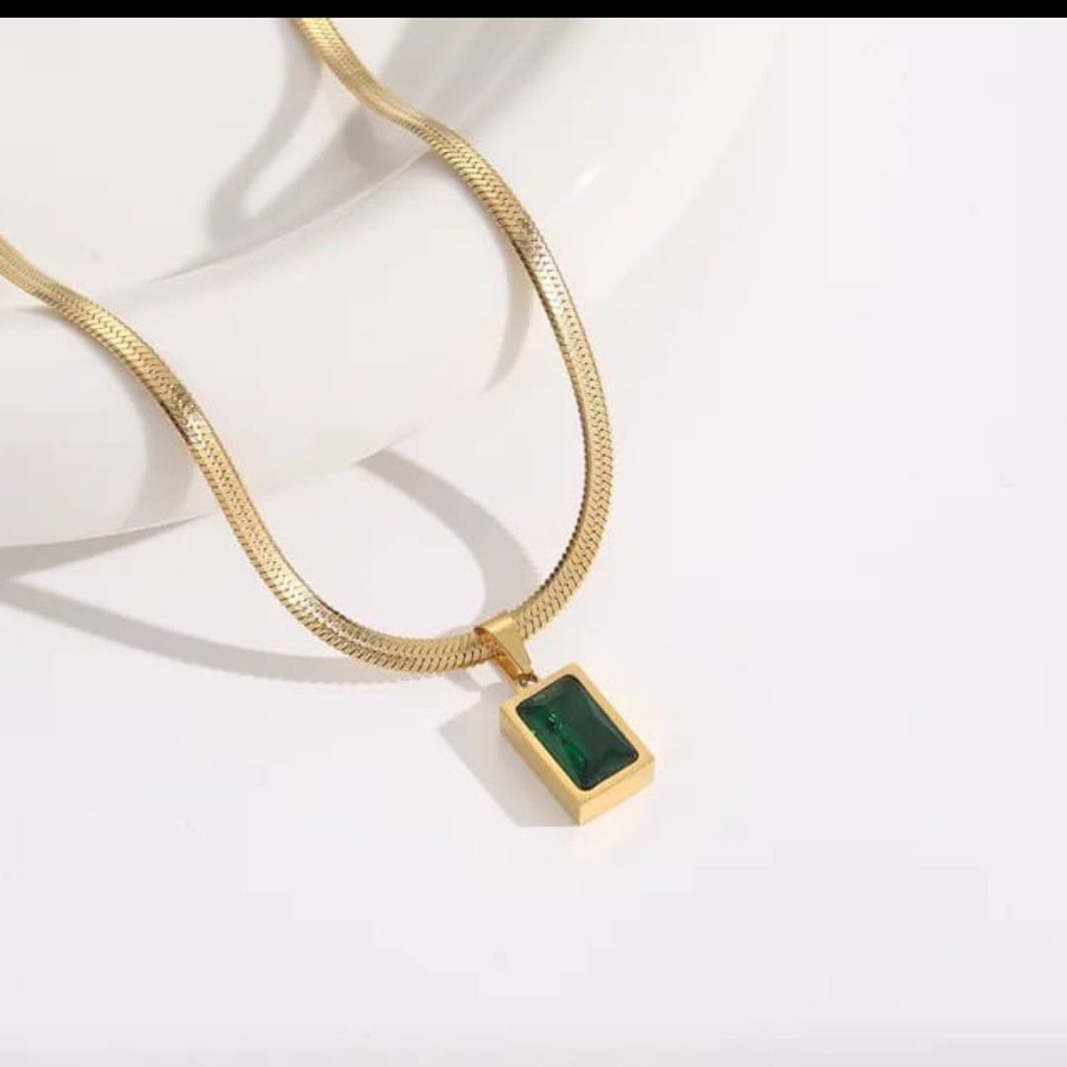 Emerald pendant necklace with green stone on flat gold chain