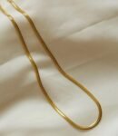 18k gold-plated herringbone chain necklace draped on cream fabric