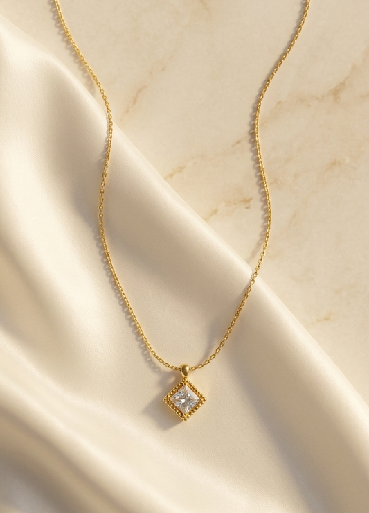Gold CZ necklace with square stone in diamond-shaped frame pendant