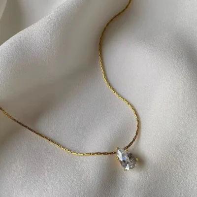 Dainty gold necklace with sparkling teardrop pendant