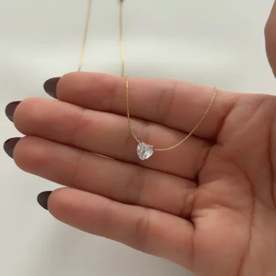Gold-tone heart pendant necklace with sparkling crystal