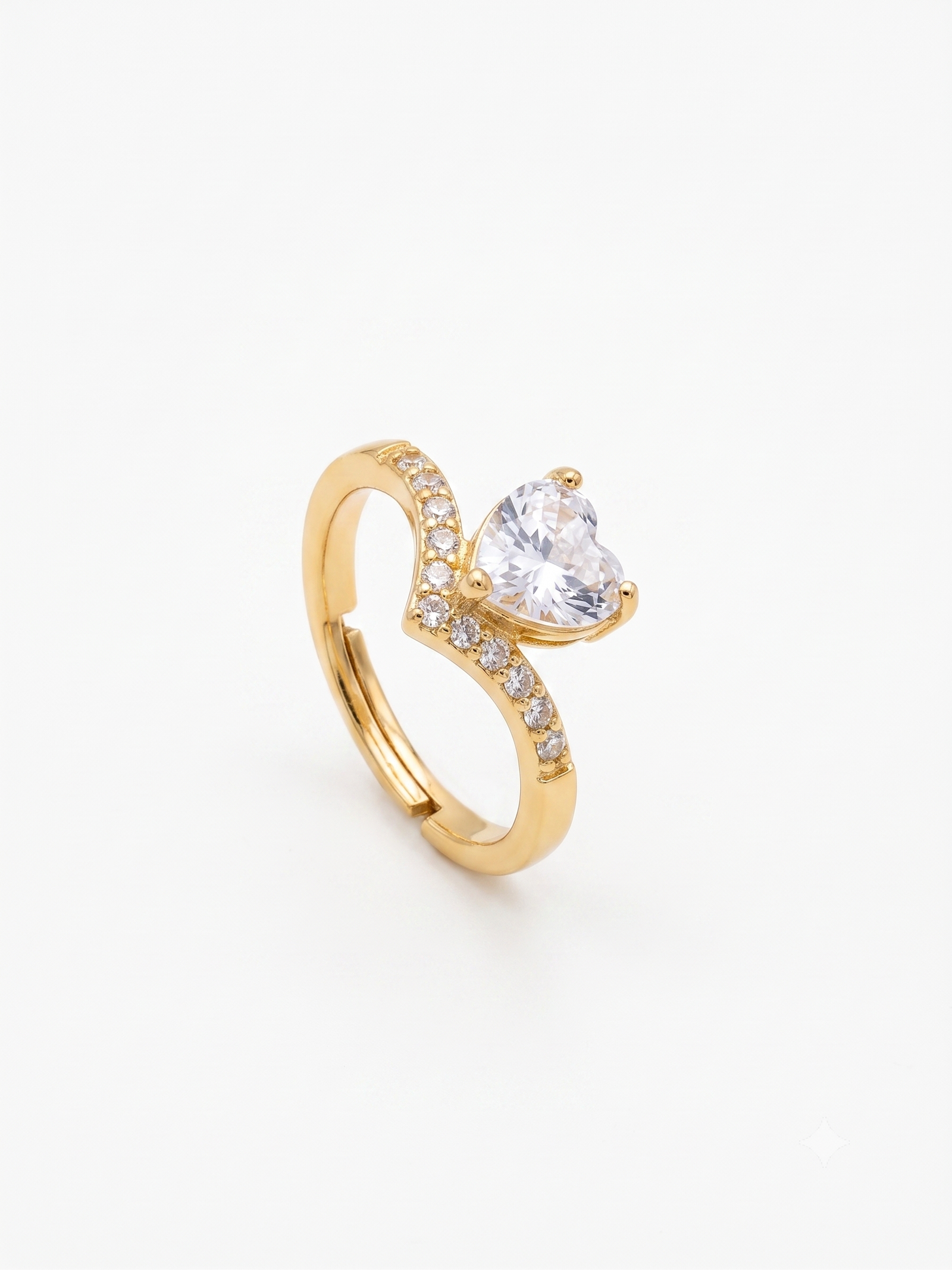 Gold heart-shaped ring with pavé chevron band on white background