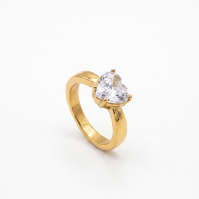 Chunky gold ring featuring large heart-cut cubic zirconia stone