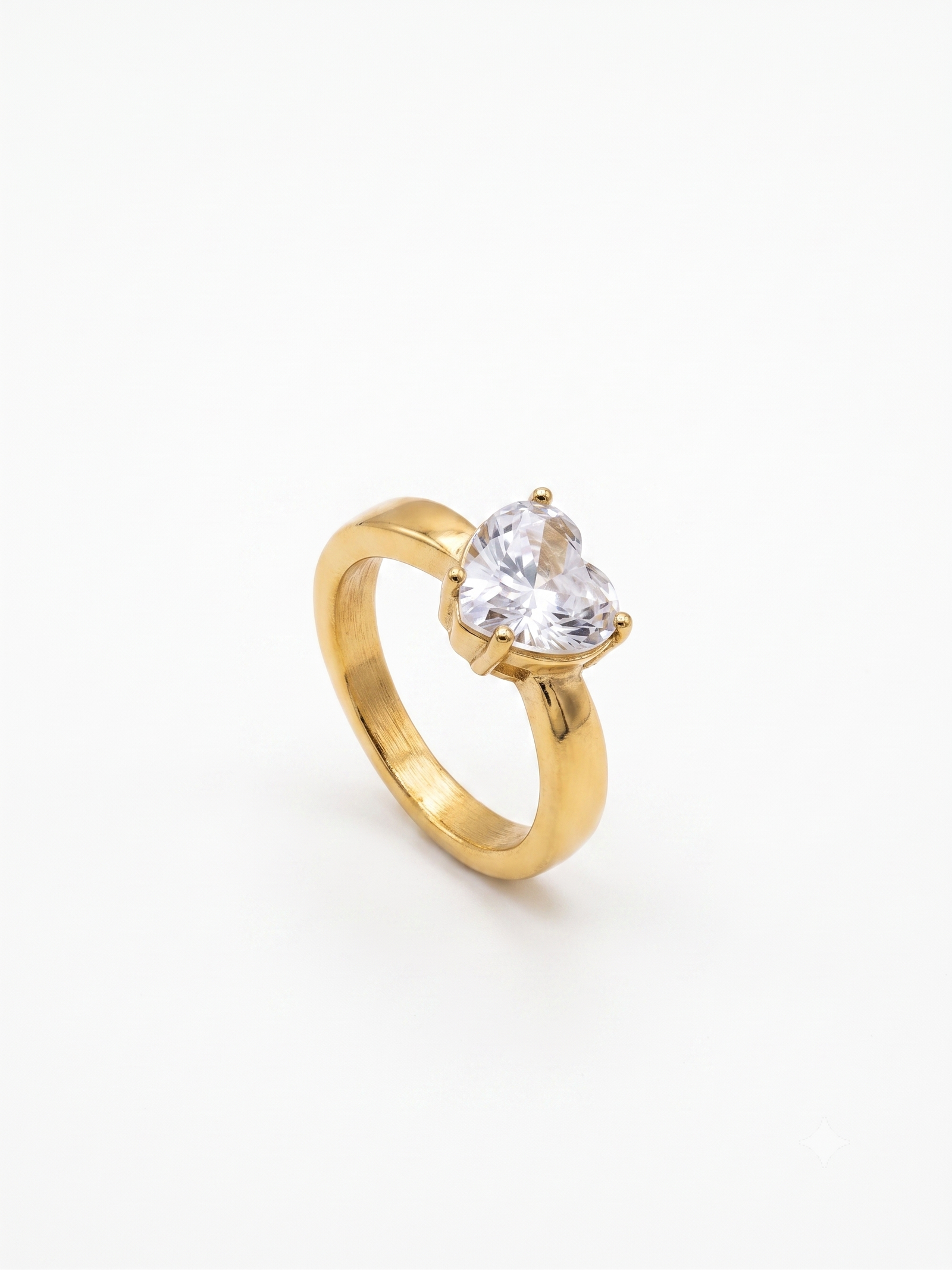 Chunky gold ring featuring large heart-cut cubic zirconia stone