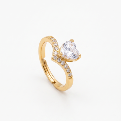 Gold heart-shaped ring with pavé chevron band on white background